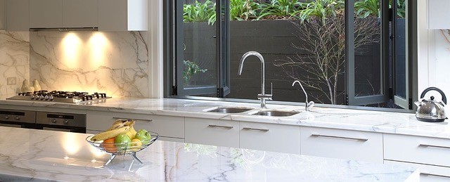 Bi-fold window at rear of kitchen sink opening out into alfresco area.